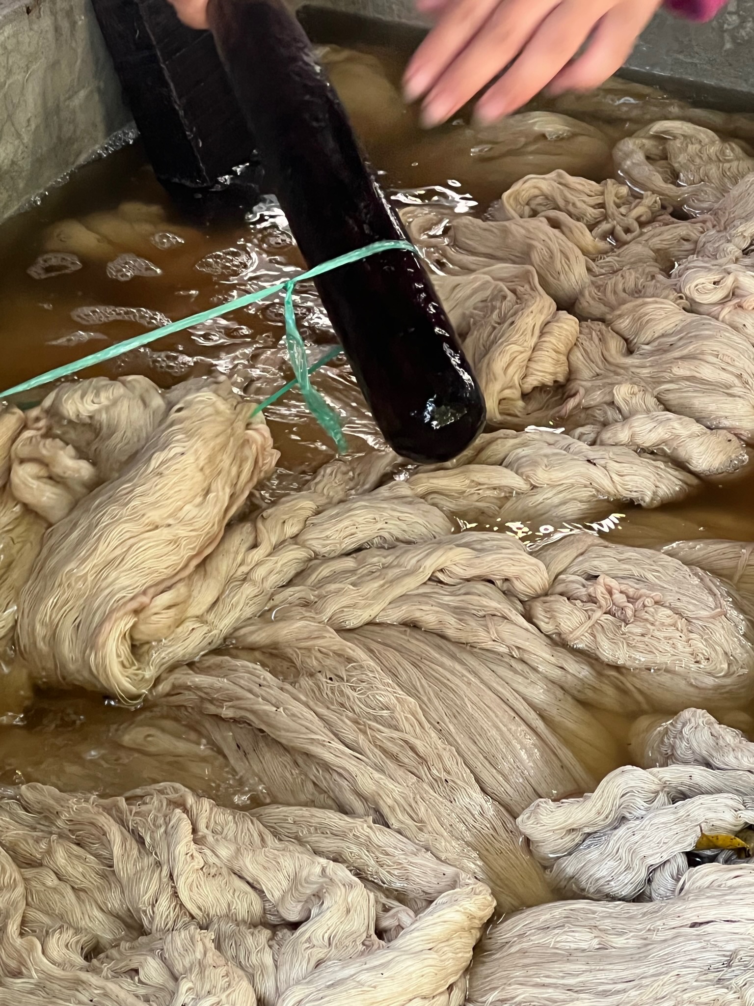 Natural dye pot steaming over flame